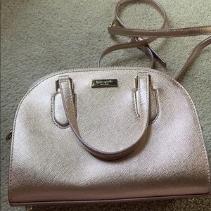 Metallic rose gold Kate Spade cross body with long detachable strap and zipper